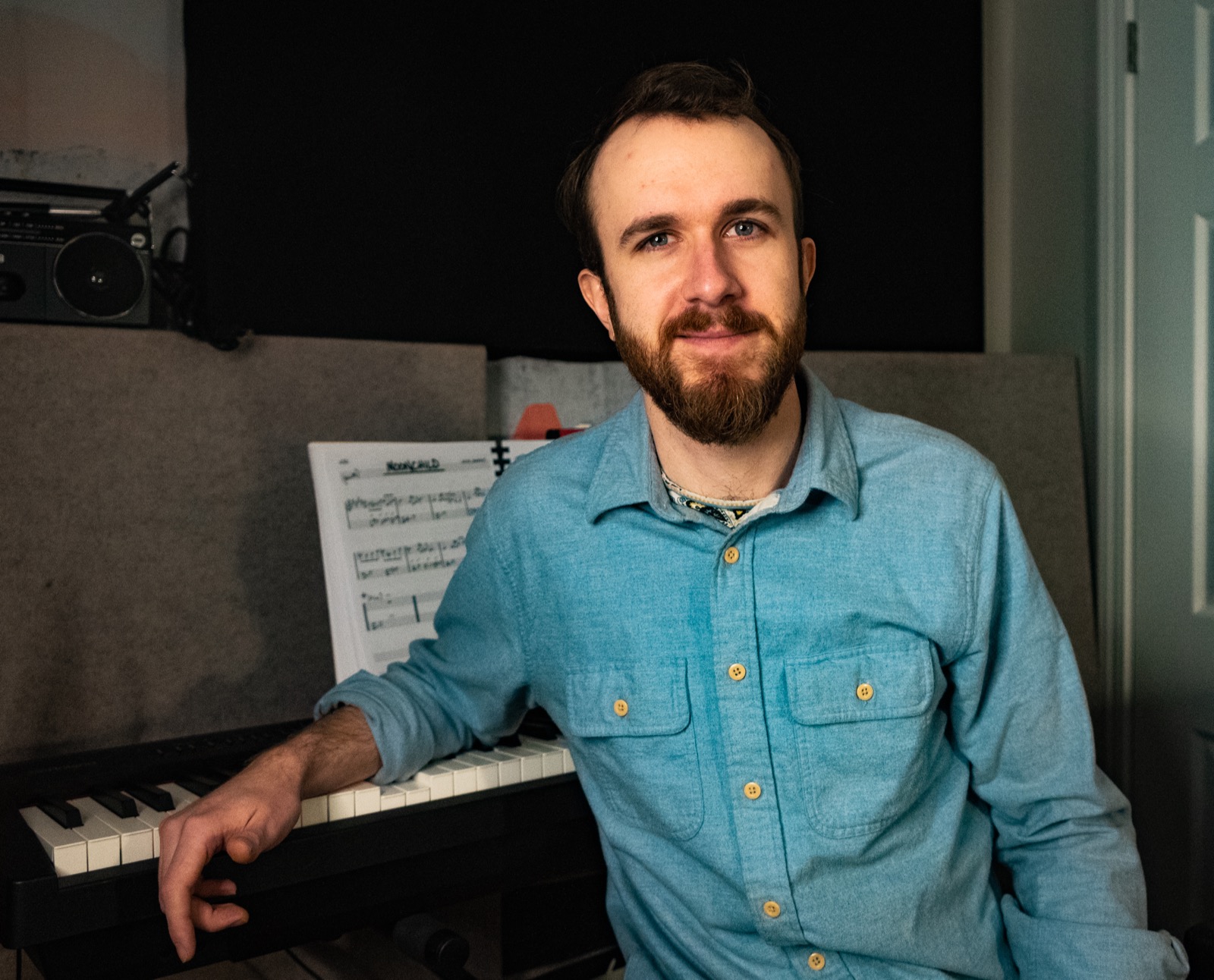 Blake Day at the piano in his home studio